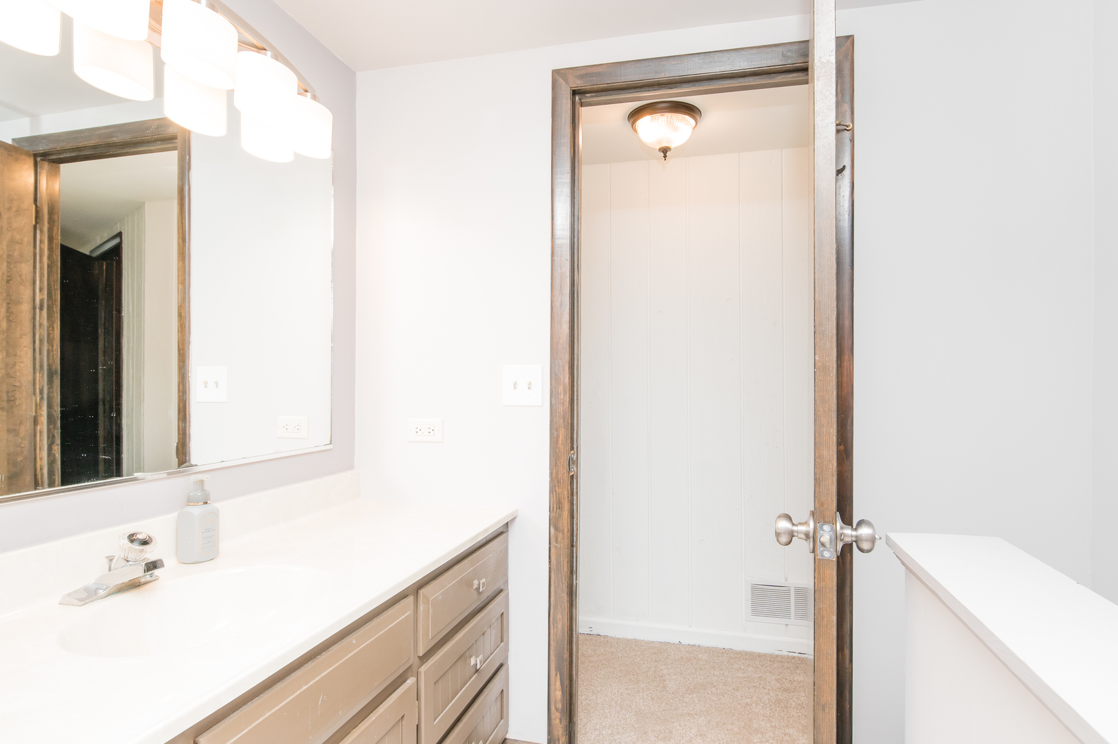 11-n060 Johnstoun Road Elgin, IL 60124 - Photo 38 of 44 a bathroom with a sink and a mirror