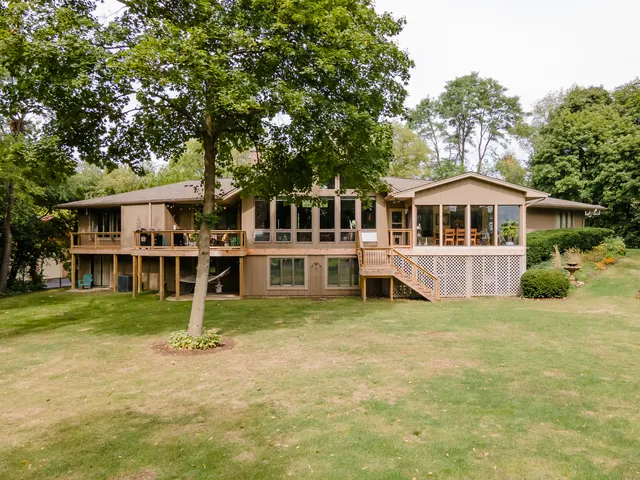 a view of a house with a yard and sitting area