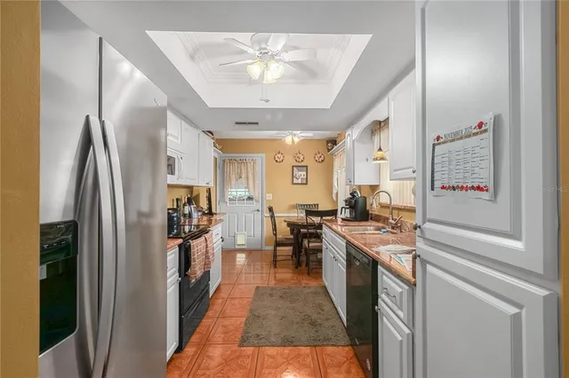 a view of a patio with table and chairs and wooden fence