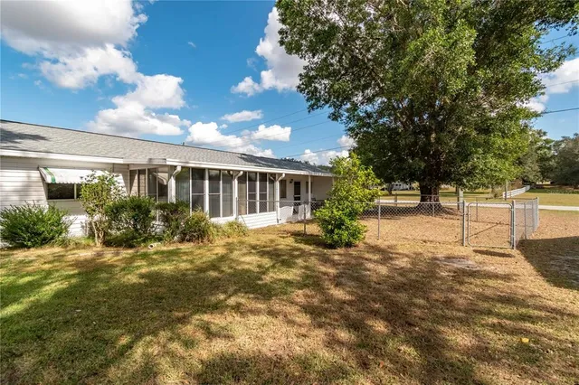 a front view of house with yard outdoor seating and barbeque oven