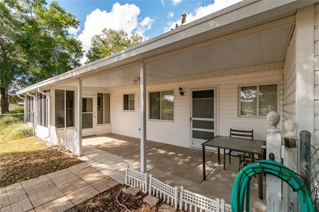 a living room with furniture a clock on wall and a table