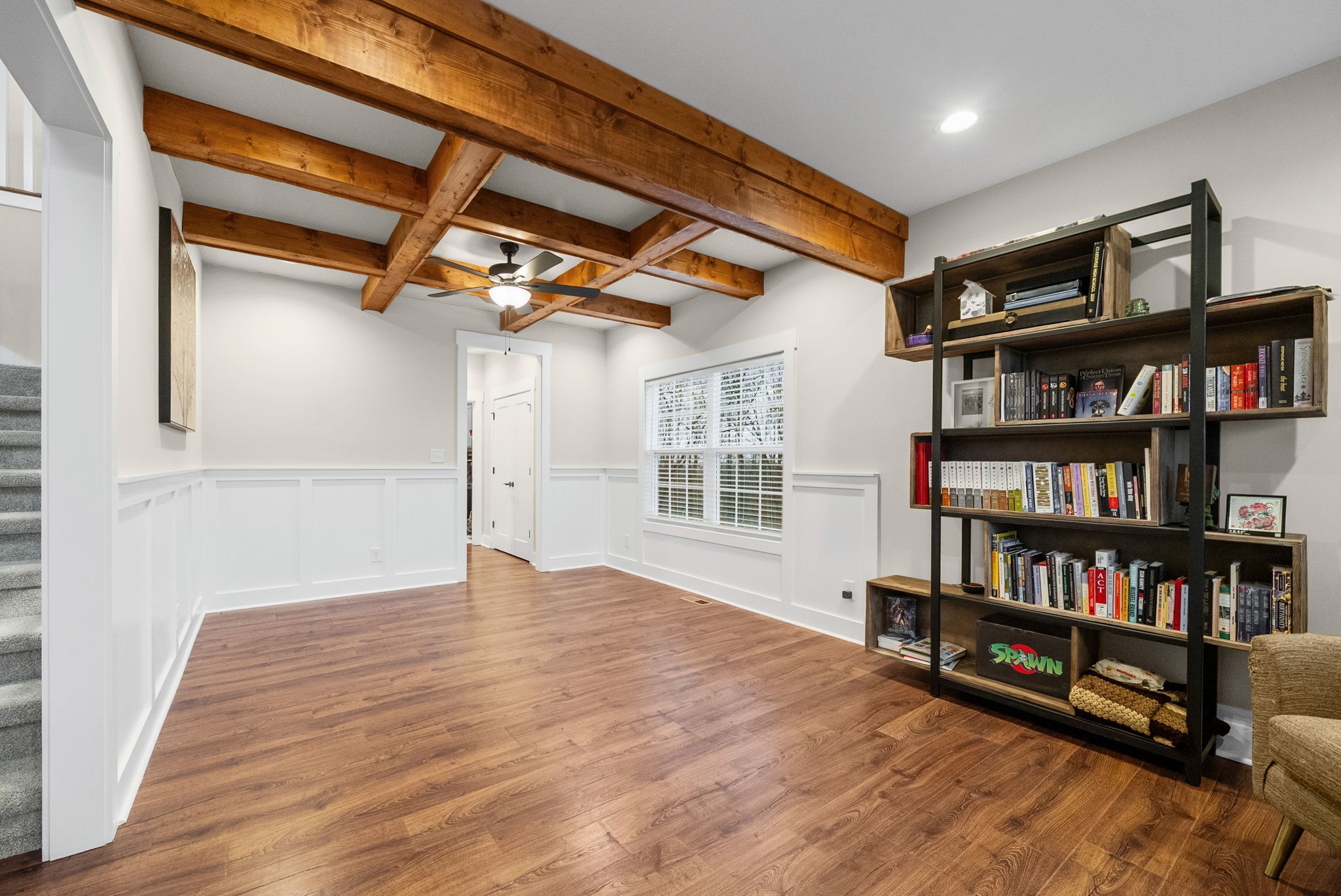 2854 Benton Ridge Road Palmyra, TN 37142 - Photo 23 of 64 a view of an empty room with bookshelf and a wooden floor