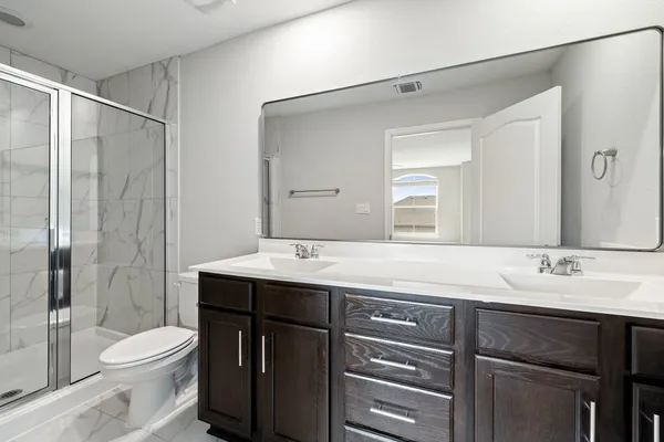 a bathroom with a sink vanity mirror and toilet
