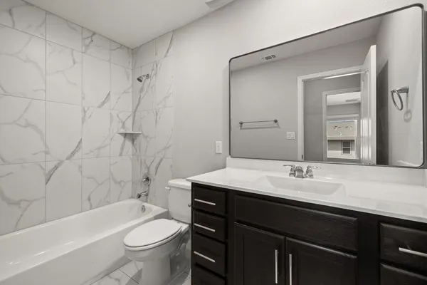 a bathroom with a sink a toilet and a bathtub