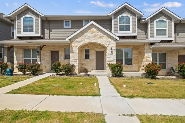 a front view of a house with yard and porch