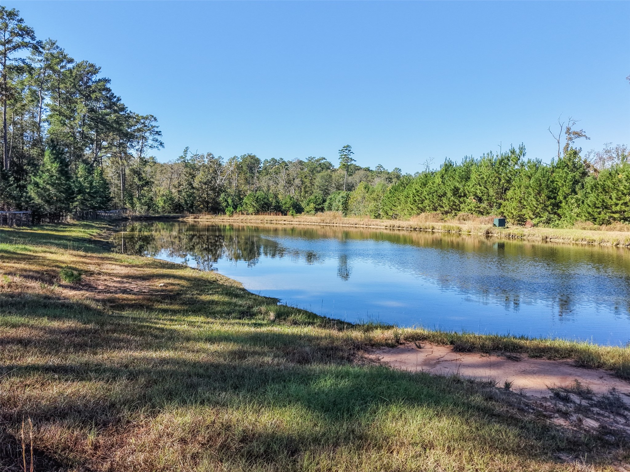 64 Gourd Creek Cemetary Road Huntsville, TX 77340 - Photo 26 of 34 a view of a lake with houses in the back