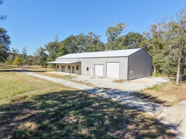 a backyard of a house with large trees and outdoor space