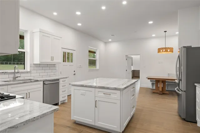 a kitchen with a sink stove and refrigerator