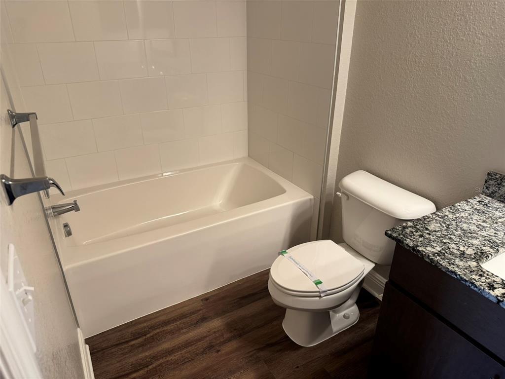 2460 Ann Rou Road, Unit 606 Tavares, FL 32778 - Photo 8 of 18 a white toilet sitting next to a bath tub