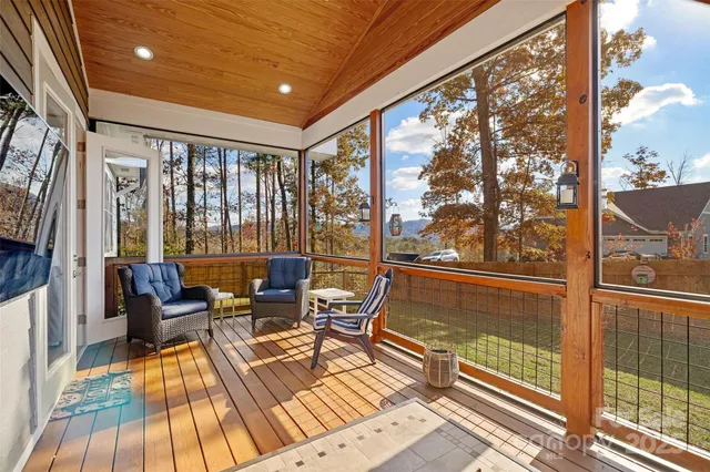 a living room with large windows and wooden floor