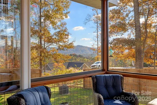 a view of a balcony with couches and wooden floor