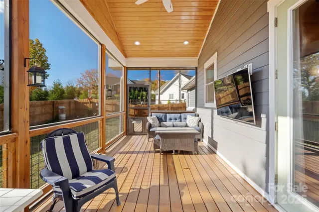 a balcony with chairs and wooden floor