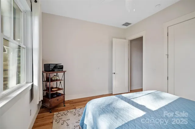 a bedroom with a bed and a book shelf