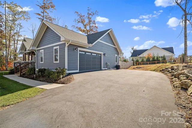 a view of a house with a yard and garage