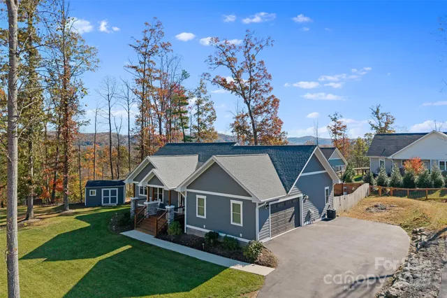 a aerial view of a house with a big yard and potted plants