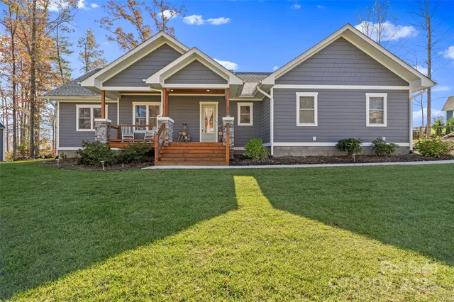 a front view of a house with a yard and green space