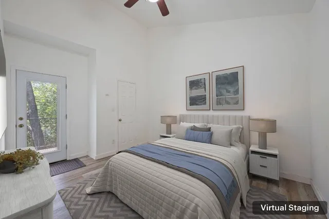 a bedroom with a bed and a flat tv screen on wall