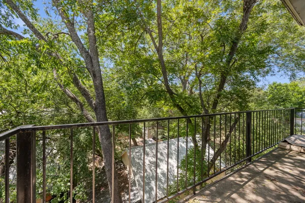 a view of balcony with wooden floor and outdoor seating