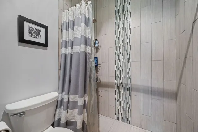 a bathroom with a double vanity sink mirror and shower