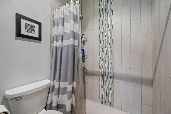 a bathroom with a double vanity sink mirror and shower