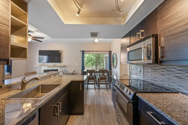 a kitchen with a stove a sink and a refrigerator