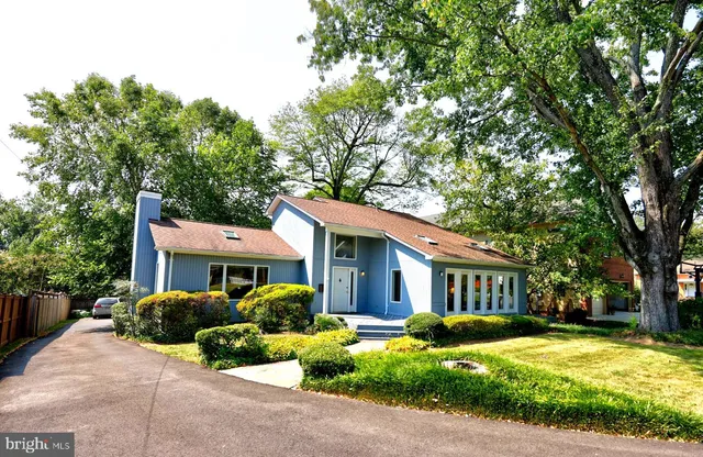 a front view of a house with yard and green space