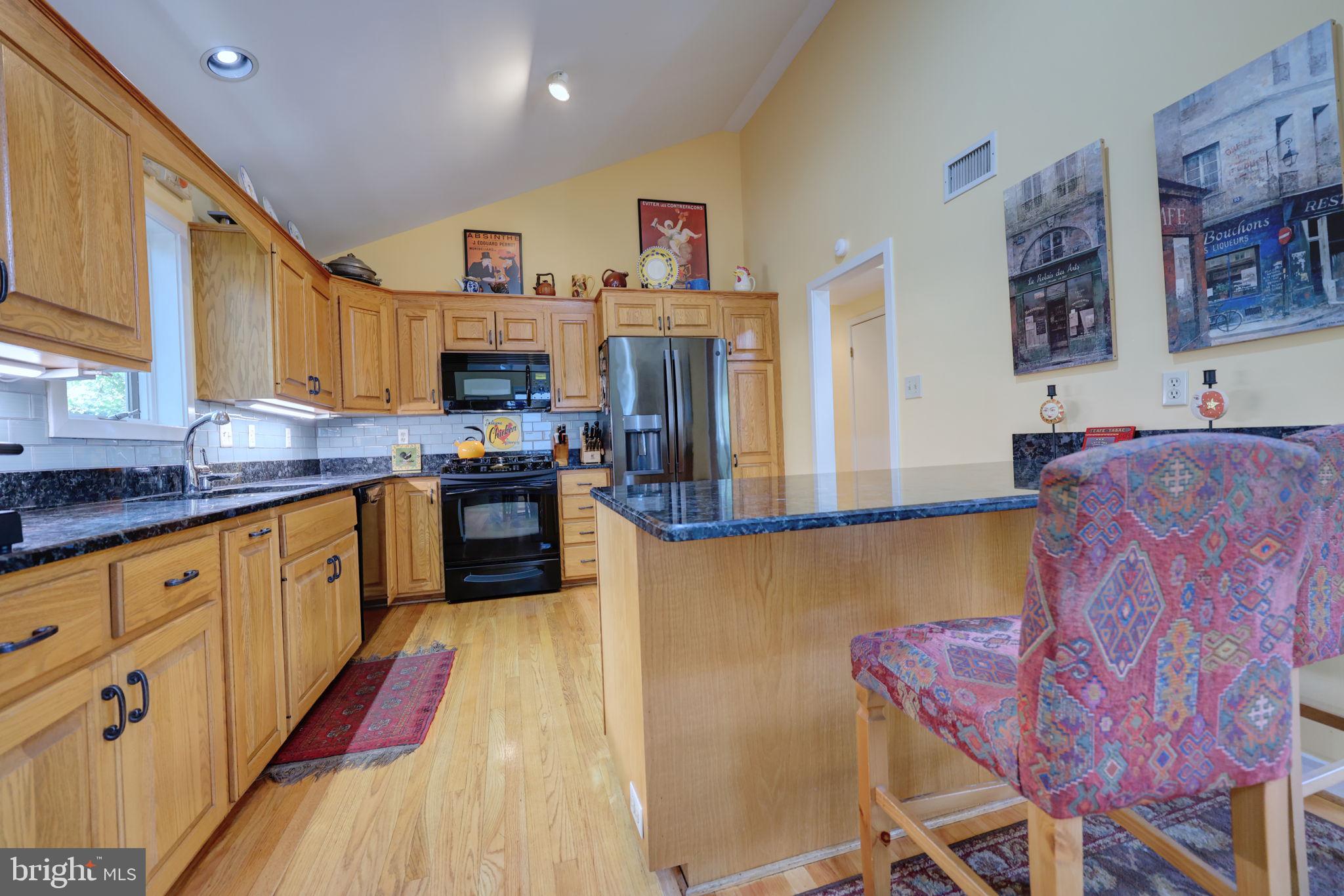 1410 Cedar Avenue McLean, VA 22101 - Photo 11 of 61 a kitchen with stainless steel appliances granite countertop a stove a sink dishwasher and a refrigerator with wooden floor
