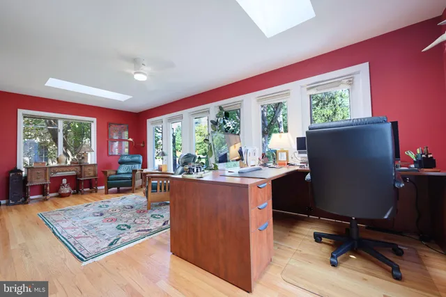 a living room with furniture and a book shelf