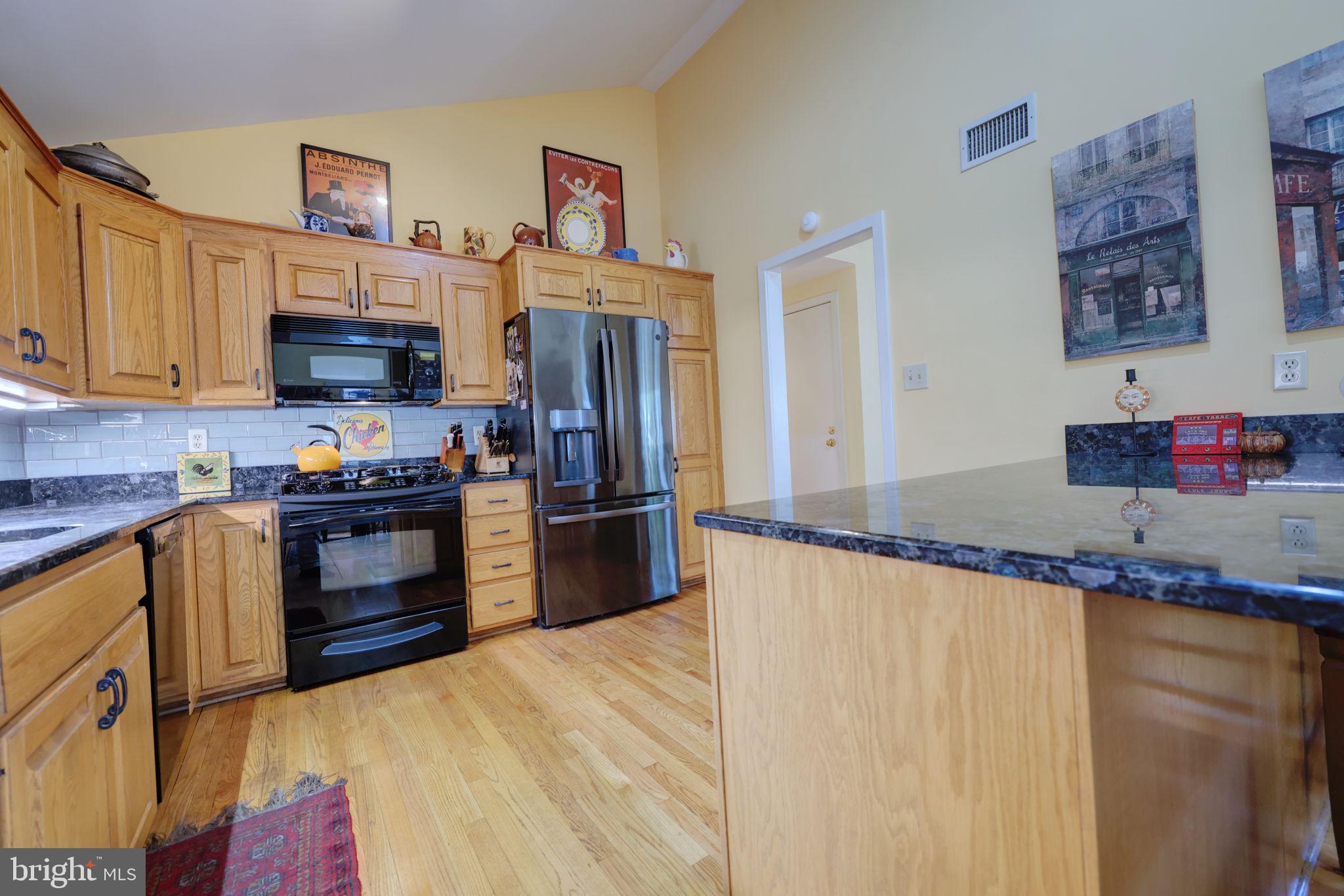 1410 Cedar Avenue McLean, VA 22101 - Photo 10 of 61 a kitchen with granite countertop stainless steel appliances a refrigerator and a stove top oven