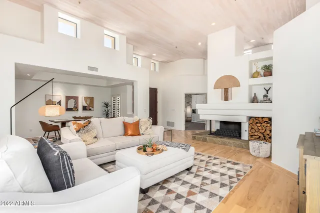 a living room with furniture and a fireplace