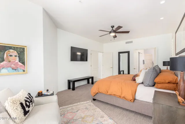 a bedroom with a bed and ceiling fan