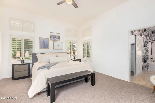 a bedroom with a bed and cabinets