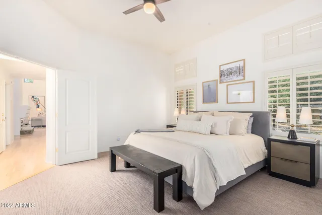 a bedroom with a bed and a chandelier
