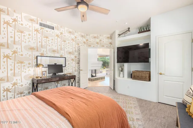 a bedroom with a bed and a flat screen tv