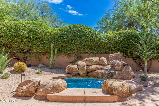 a bedroom with a bed and a potted plant