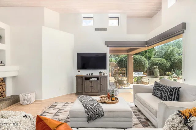 a living room with furniture fireplace and a flat screen tv