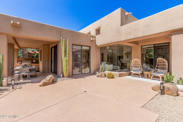 a view of a house with outdoor seating space