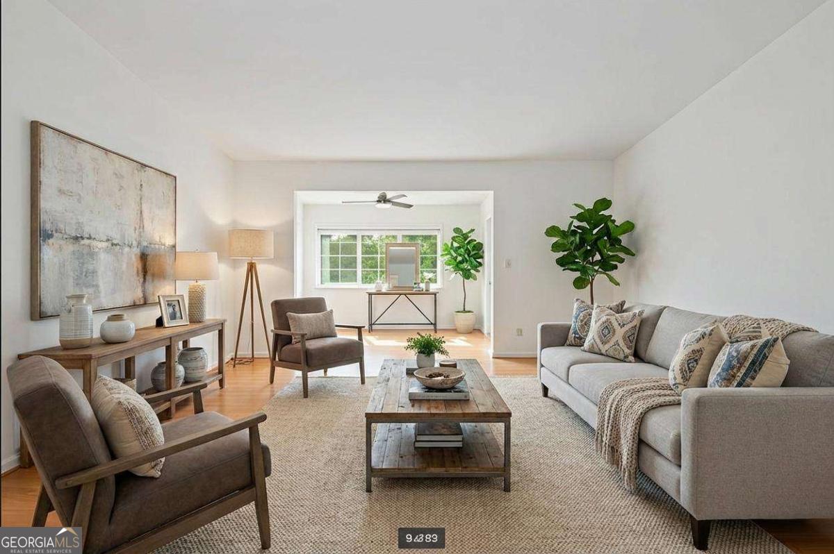 a living room with furniture and a large window