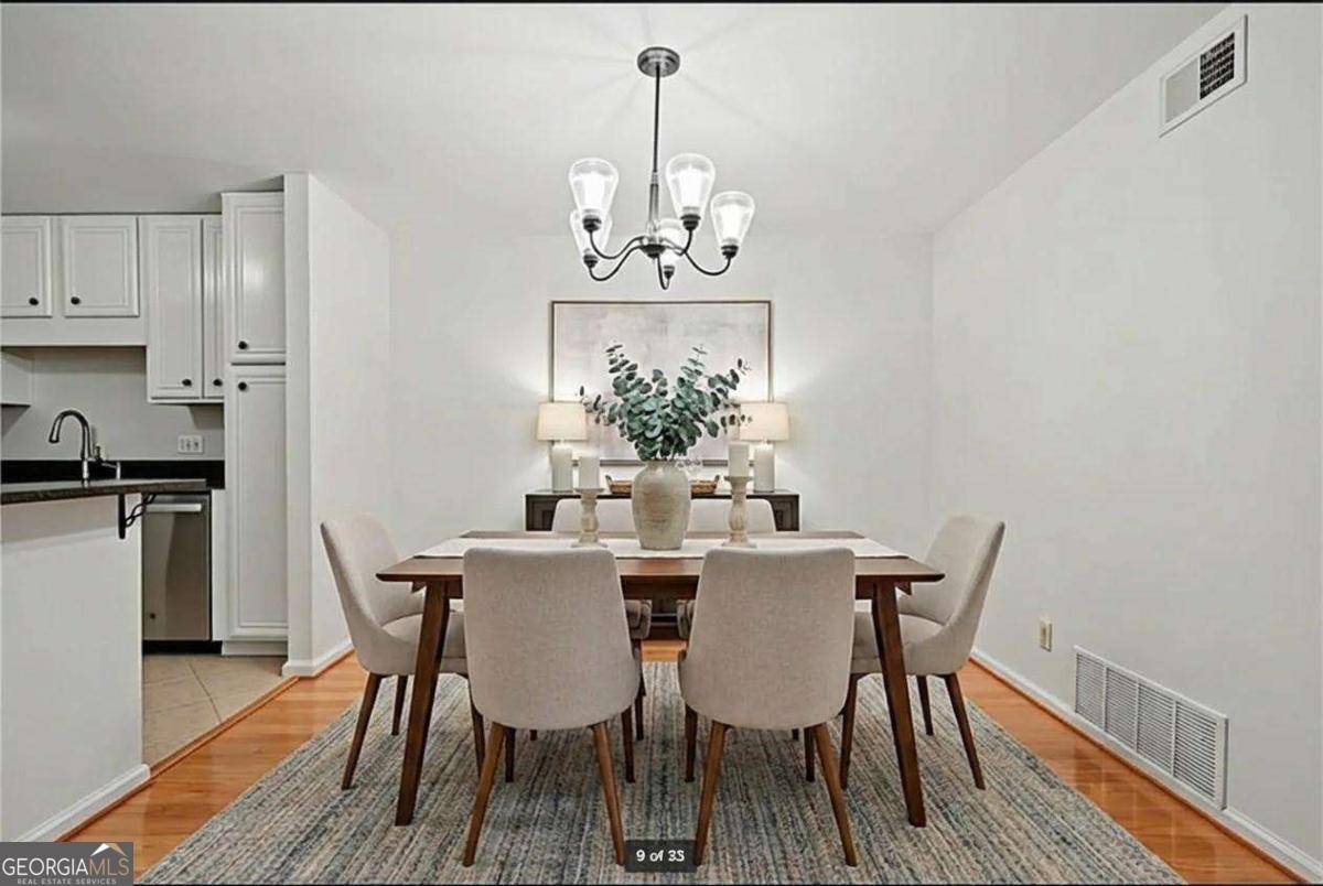 1468 Briarwood Road Northeast, Unit 108 Atlanta, GA 30319 - Photo 2 of 5 a view of a dining room with furniture and chandelier