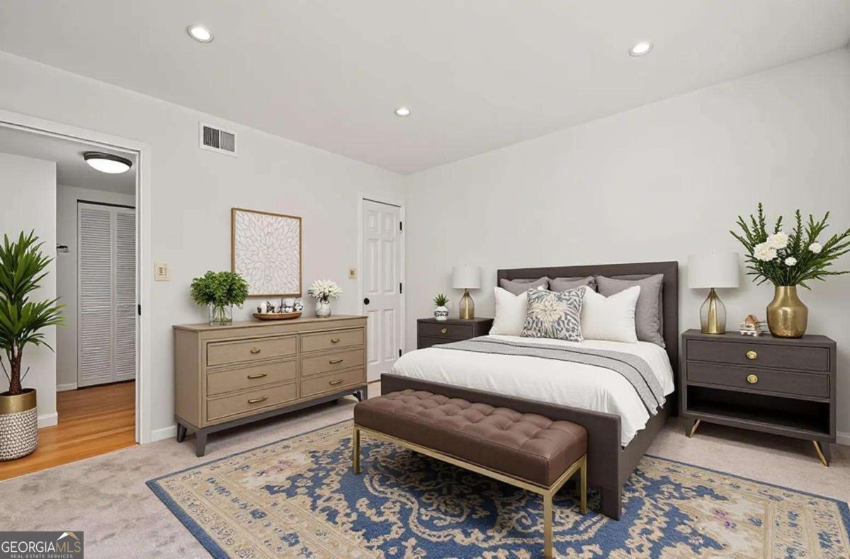 1468 Briarwood Road Northeast, Unit 108 Atlanta, GA 30319 - Photo 4 of 5 a bedroom with a bed and a potted plant