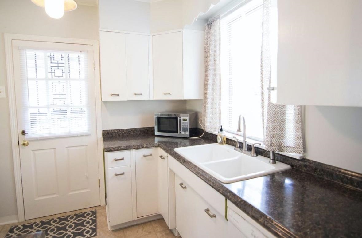 699 Shotwell Street Memphis, TN 38111 - Photo 13 of 33 Kitchen with white cabinetry, stainless steel microwave, and dishwasher