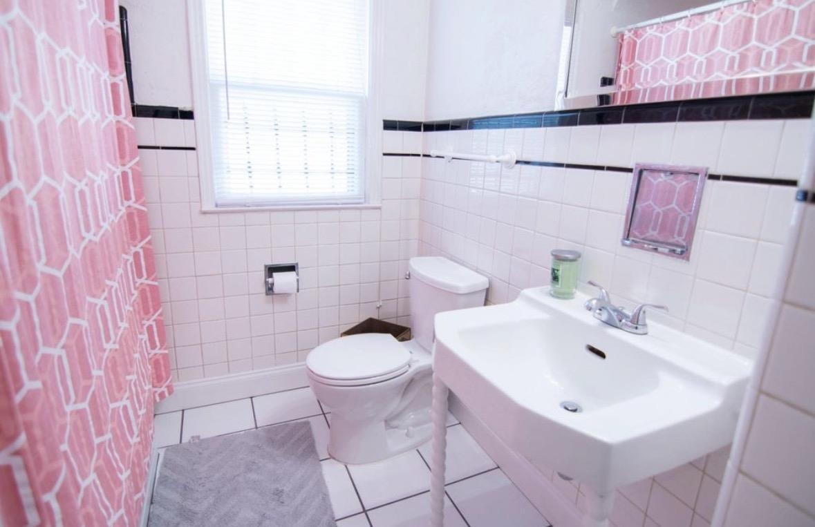 699 Shotwell Street Memphis, TN 38111 - Photo 23 of 33 Full bath featuring a shower with curtain, tile patterned floors, and tile walls