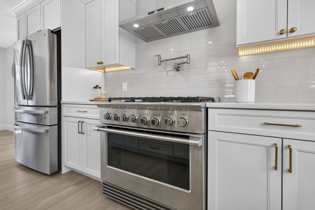 20 Saltonstall Road Medford, MA 02155 - Photo 13 of 41 a kitchen with a stove and a refrigerator
