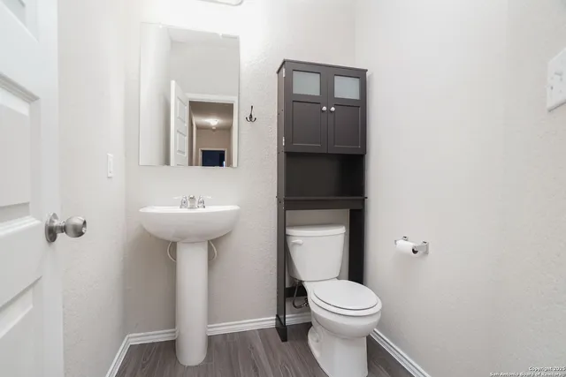 a white toilet sitting next to a bathroom sink