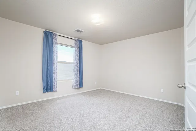 a view of a backyard with a small cabin and wooden fence