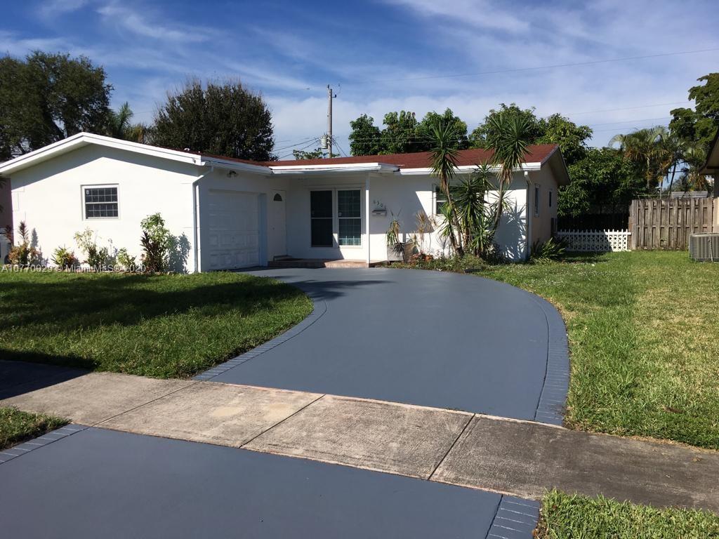 6301 Raleigh Street Hollywood, FL 33024 - Photo 1 of 19 front view of a house with a yard