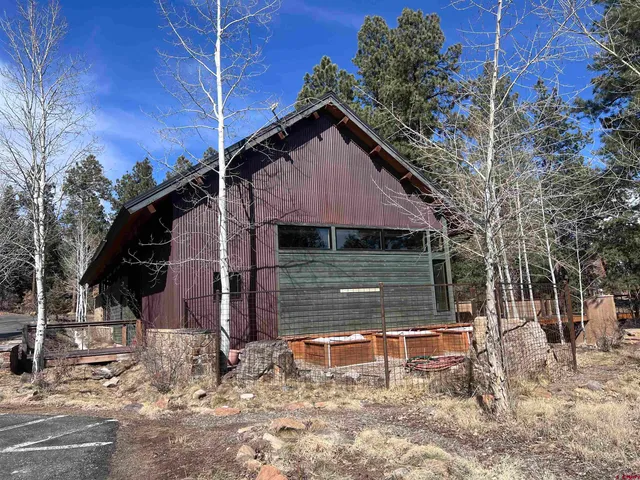 a view of a yard with wooden fence