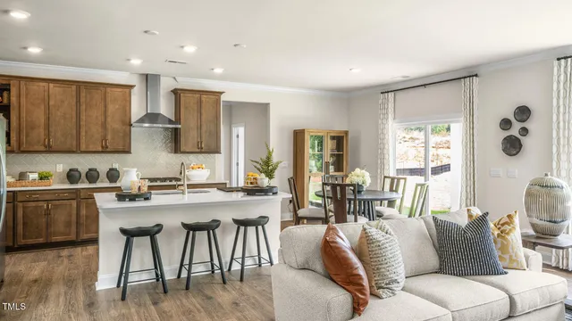 a living room with stainless steel appliances granite countertop furniture a couch and a view of kitchen