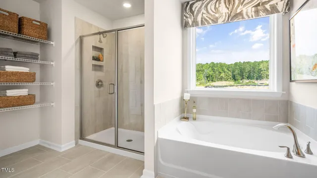 a white bath tub sitting next to a shower