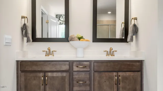 a bathroom with double sink and a mirror